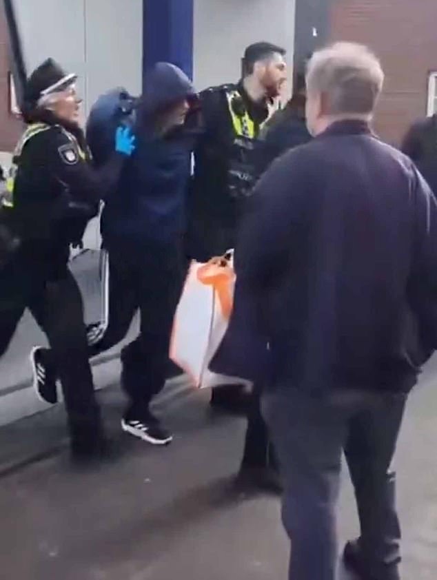 Chilling moment hooded woman, 39, is arrested after 18 were stabbed in Hamburg: ‘I heard everyone start screaming’ says eye witness